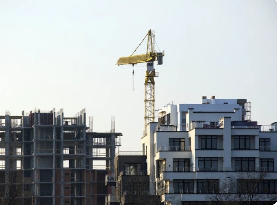Residential buildings and a building under construction, with a tower crane